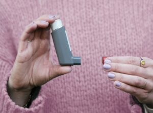 A woman holding a cell phone in her hands